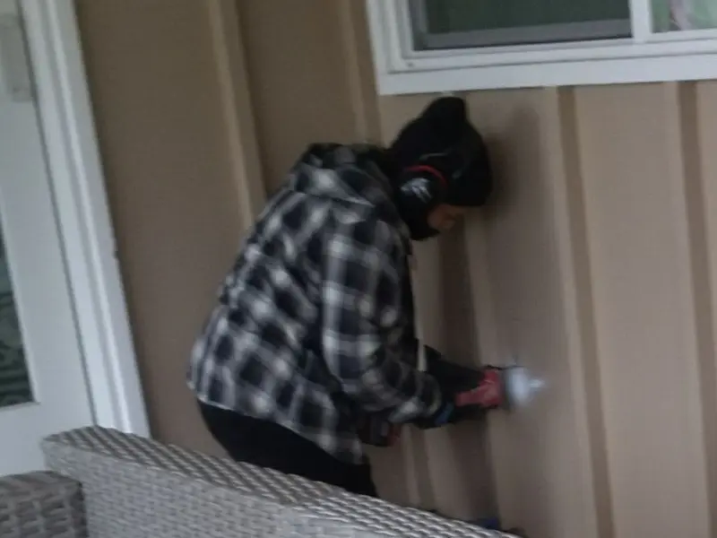 Professional electrician installing an exterior outlet in Anamosa